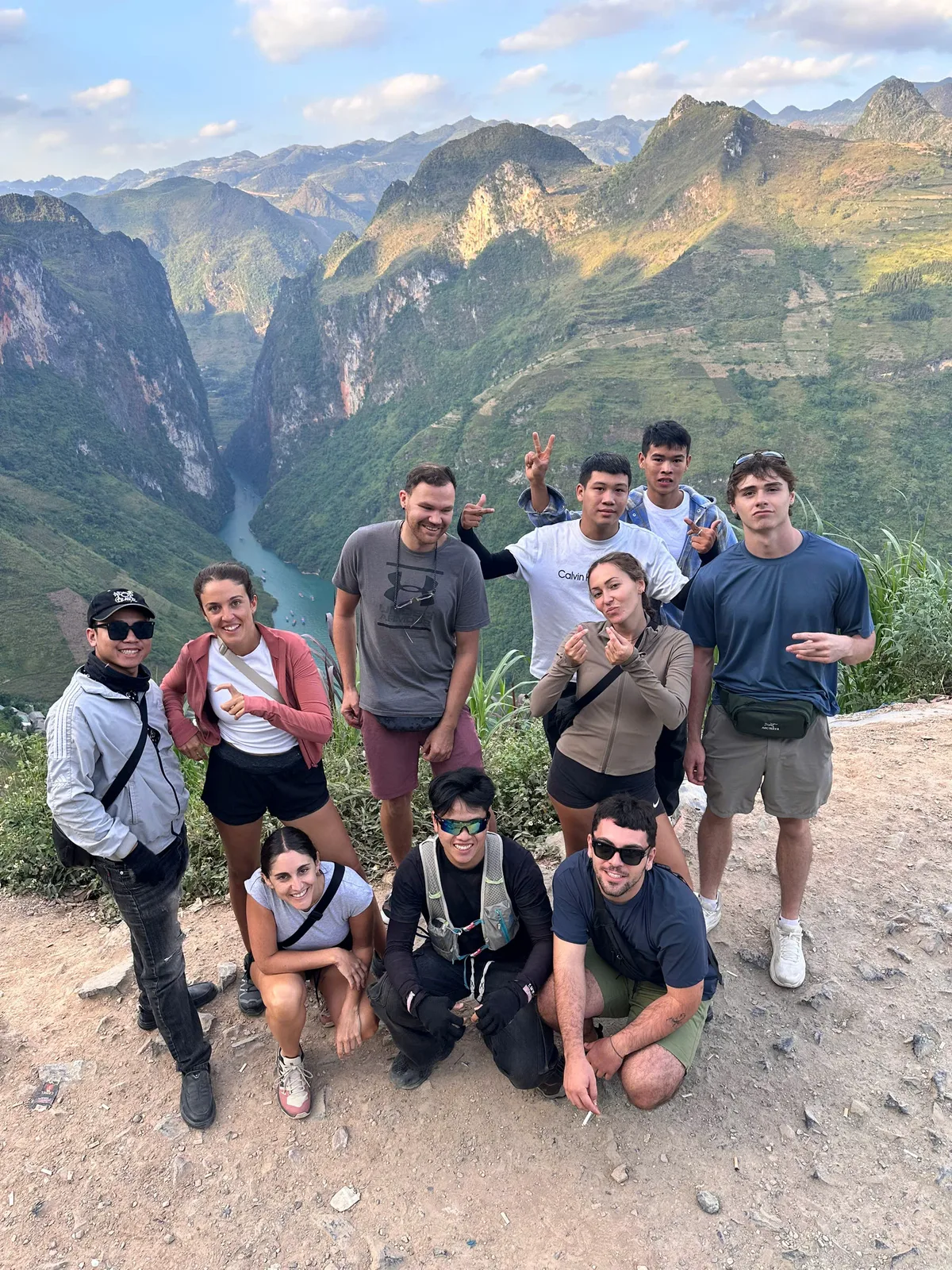 Freedom Ha Giang Loop riders and guides at a Ma Pi Leng viewpoint above the Nho Que River