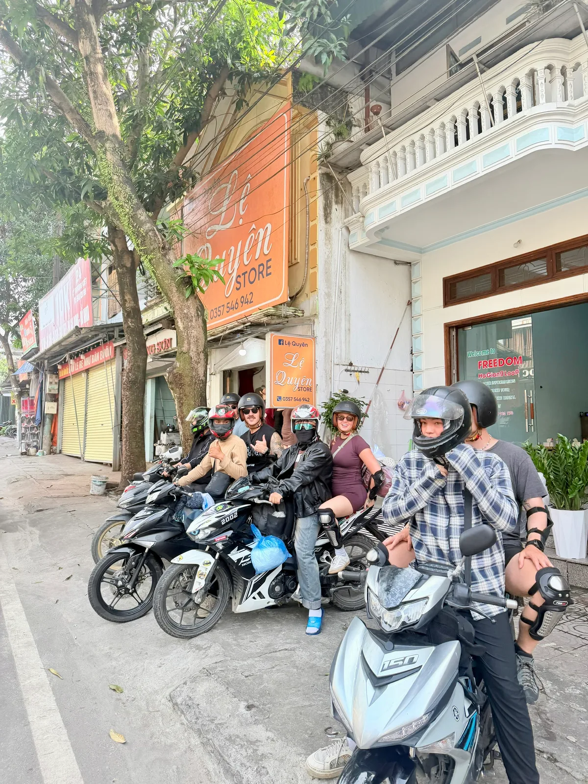 Freedom group sitting on their motorbikes with helmets on, ready to leave our office in Ha Giang city